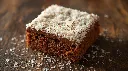 Generate an image of Lamington party coated with desicated cocunut plated in wooden table (1).webp