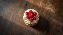 Generate an image of raspberry micro cake cylindrical shape layered topped with piping cream plated in wooden table.webp